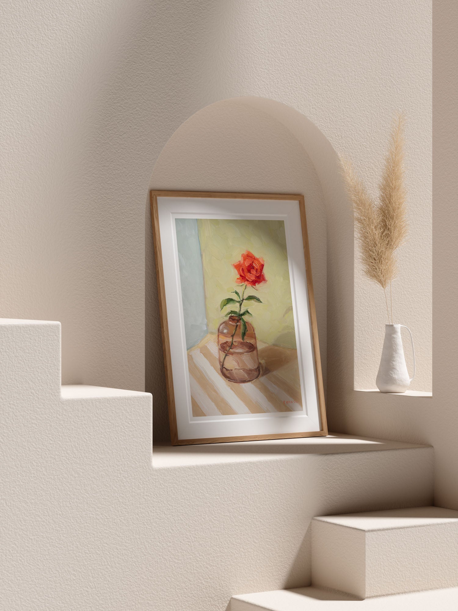 Framed artwork with a red flower on a beige wall