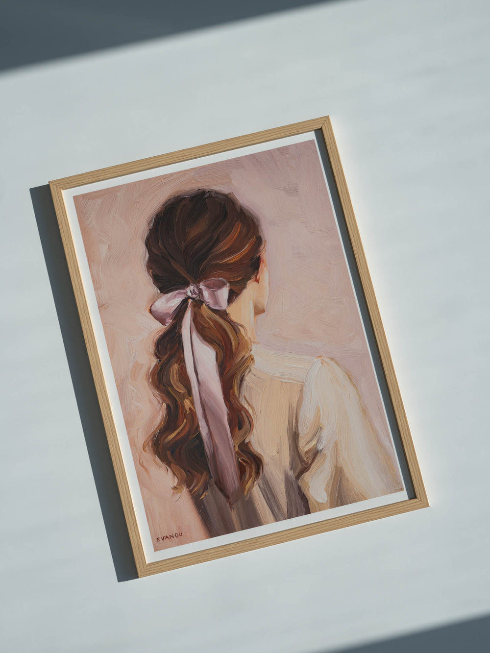 Art print of a woman with long hair tied back with a pink ribbon on a beige background