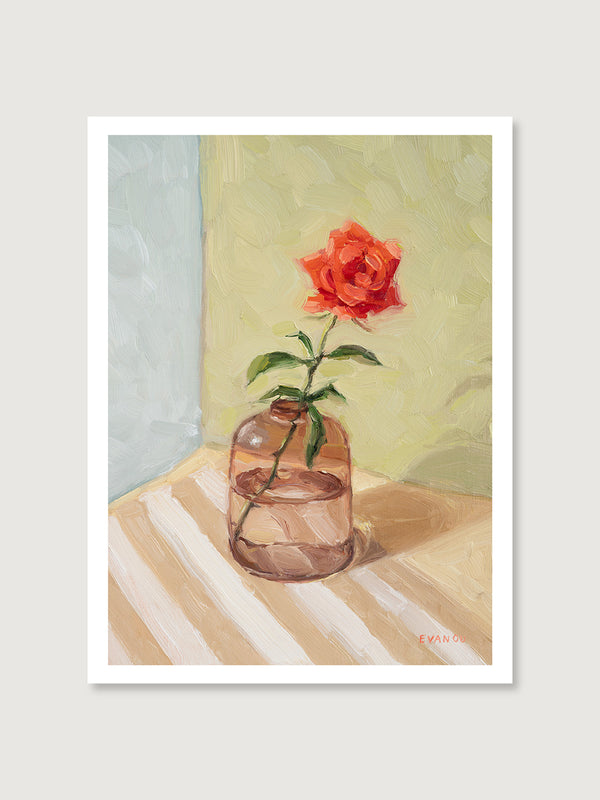 Art print of a red rose in a glass vase on a striped surface with a soft background