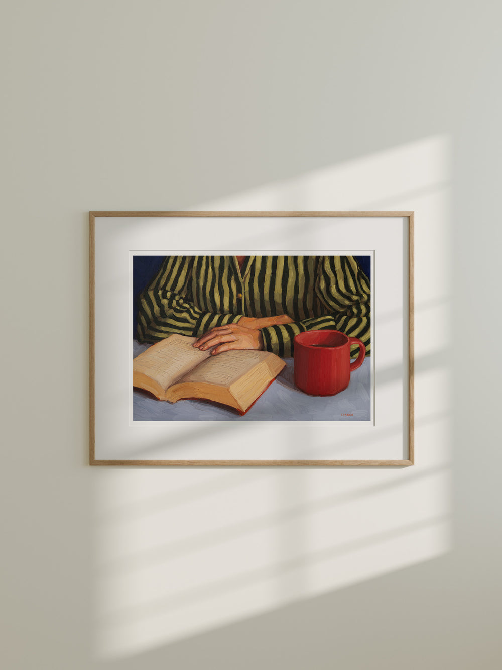 art print of a person with stripy shirt reading a book