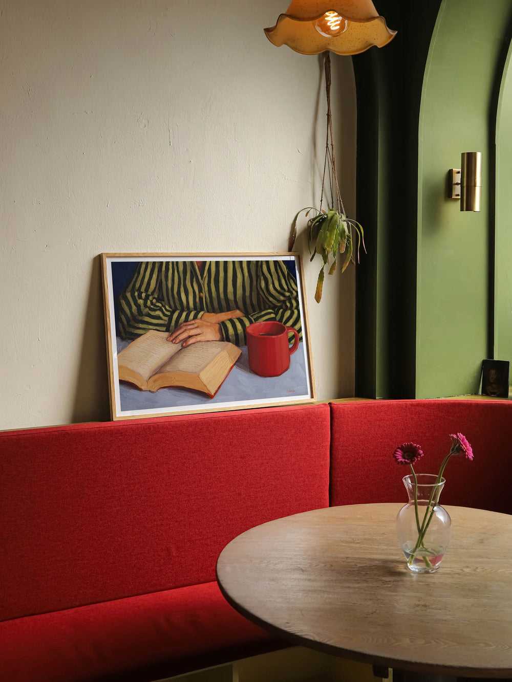 art print of a person with stripy shirt reading a book
