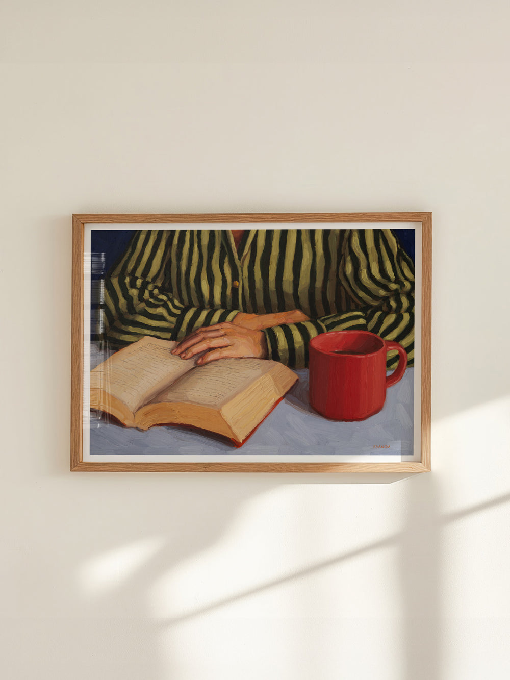 art print of a person with stripy shirt reading a book