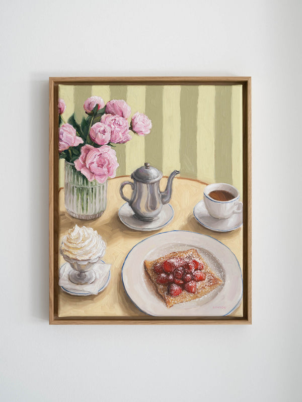 Framed artwork of a still life scene with flowers, coffee set, whipped cream and crepe with strawberries on a table.