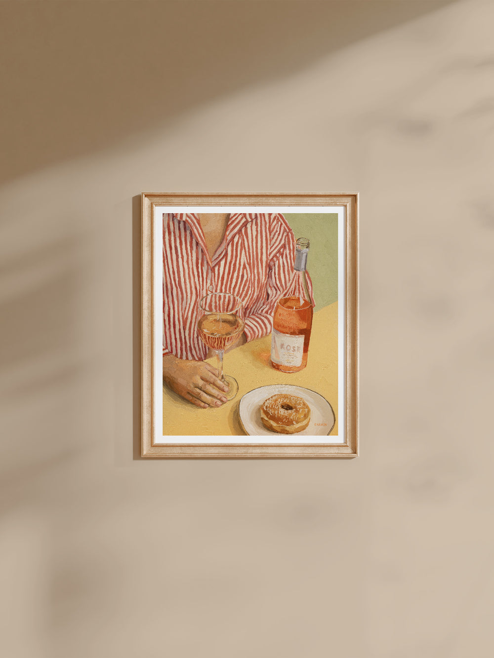 Art print of a woman dressed in a stripy shirt, seated at a table with a glass of Rosé wine and a tempting donut placed on a plate. 