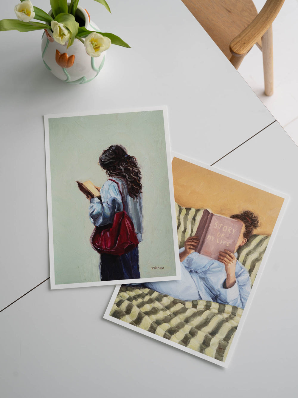 Painting of a person with long hair holding a book against a light green background
