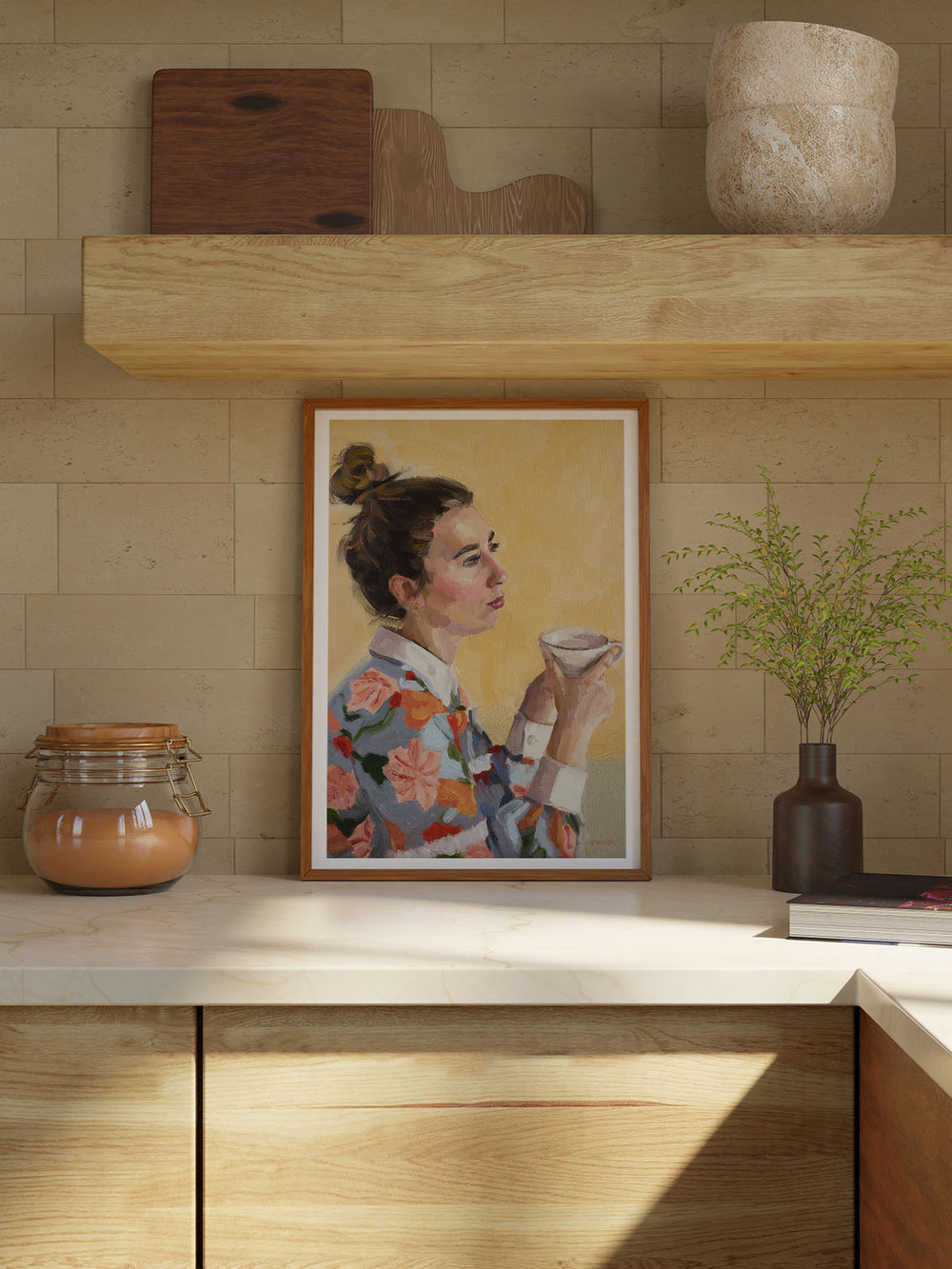 A woman, adorned in a vibrant floral shirt, sits comfortably with a cup of tea in her hands, savouring a moment of calm. 