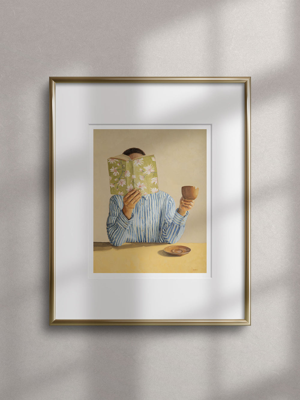 art print featuring a woman reading a book and holding a cup