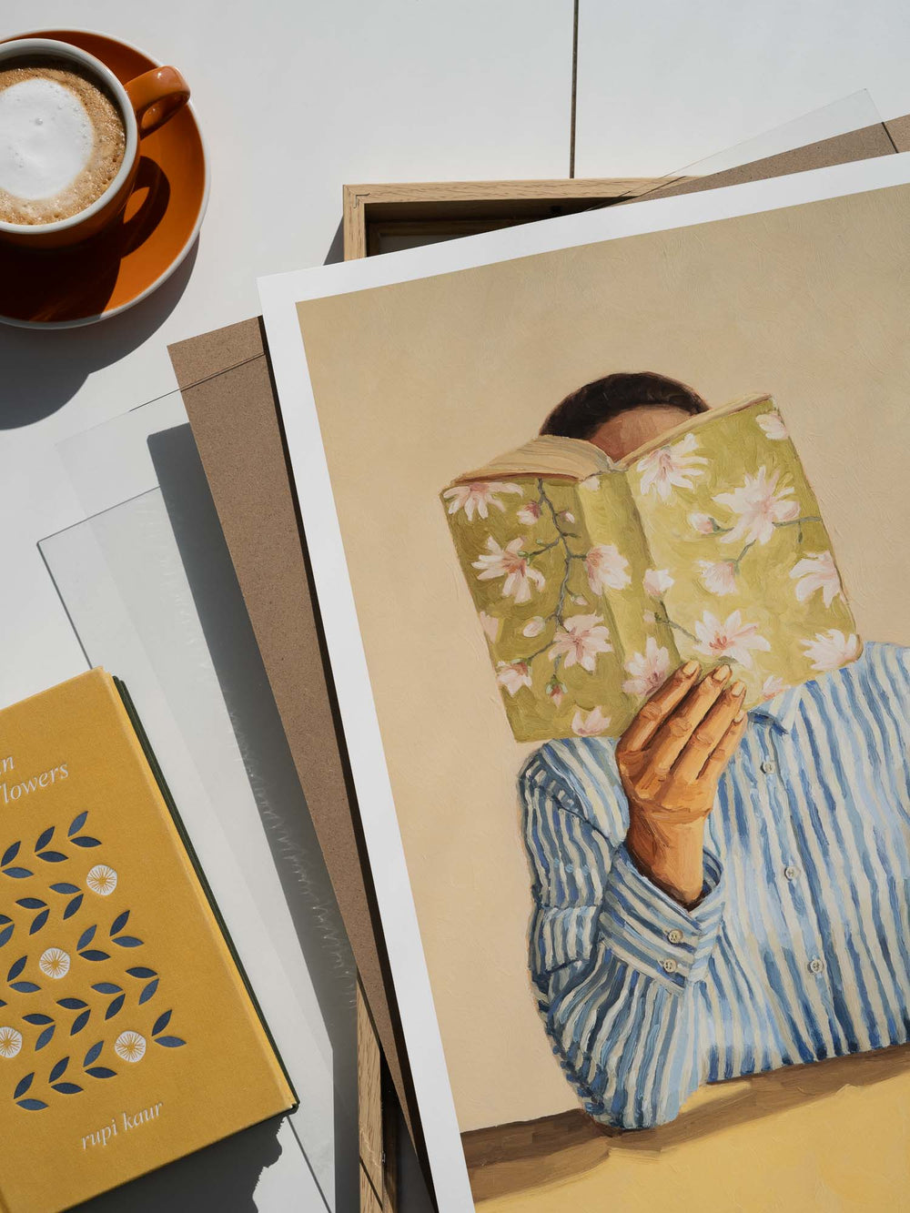 art print featuring a woman reading a book and holding a cup