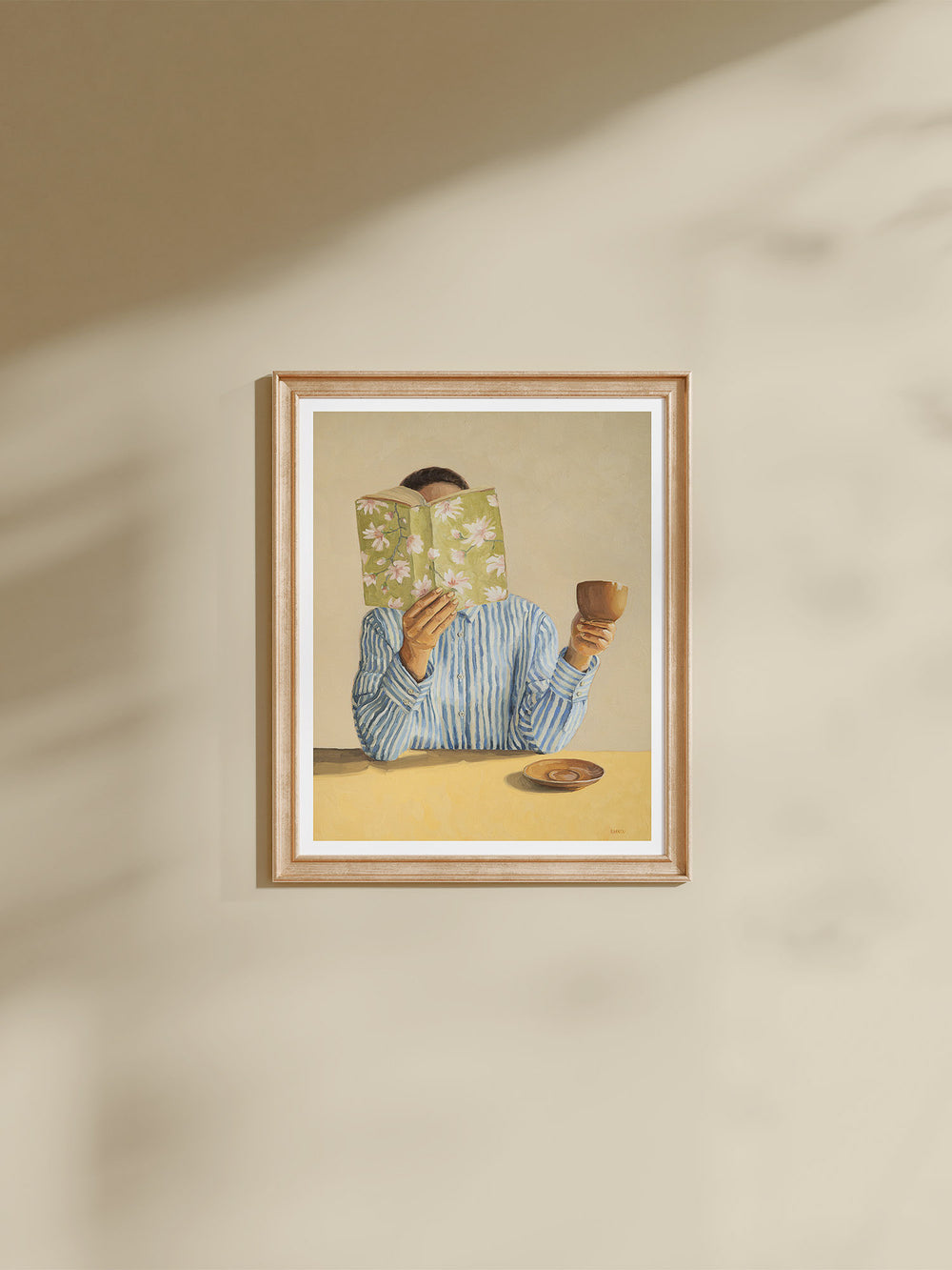 art print featuring a woman reading a book and holding a cup