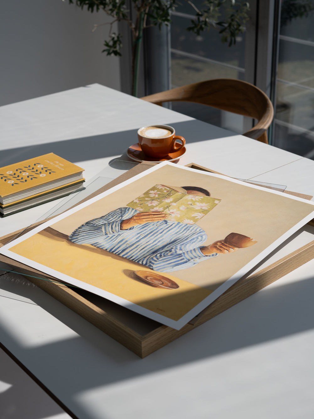 art print featuring a woman reading a book and holding a cup
