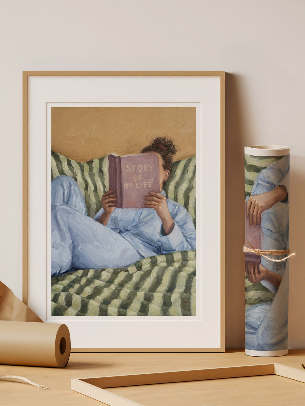 Person reading a book titled 'Story of My Life' on a striped couch.