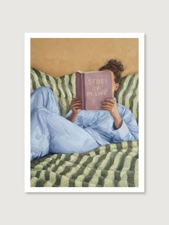 Person reading a book titled 'Story of My Life' on a striped couch.